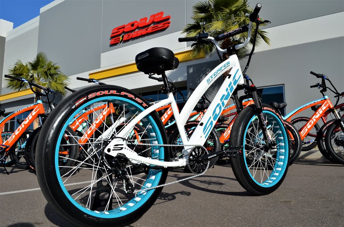 White and blue bicycle outside store display.