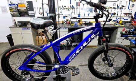 Blue bicycle in a workshop setting.