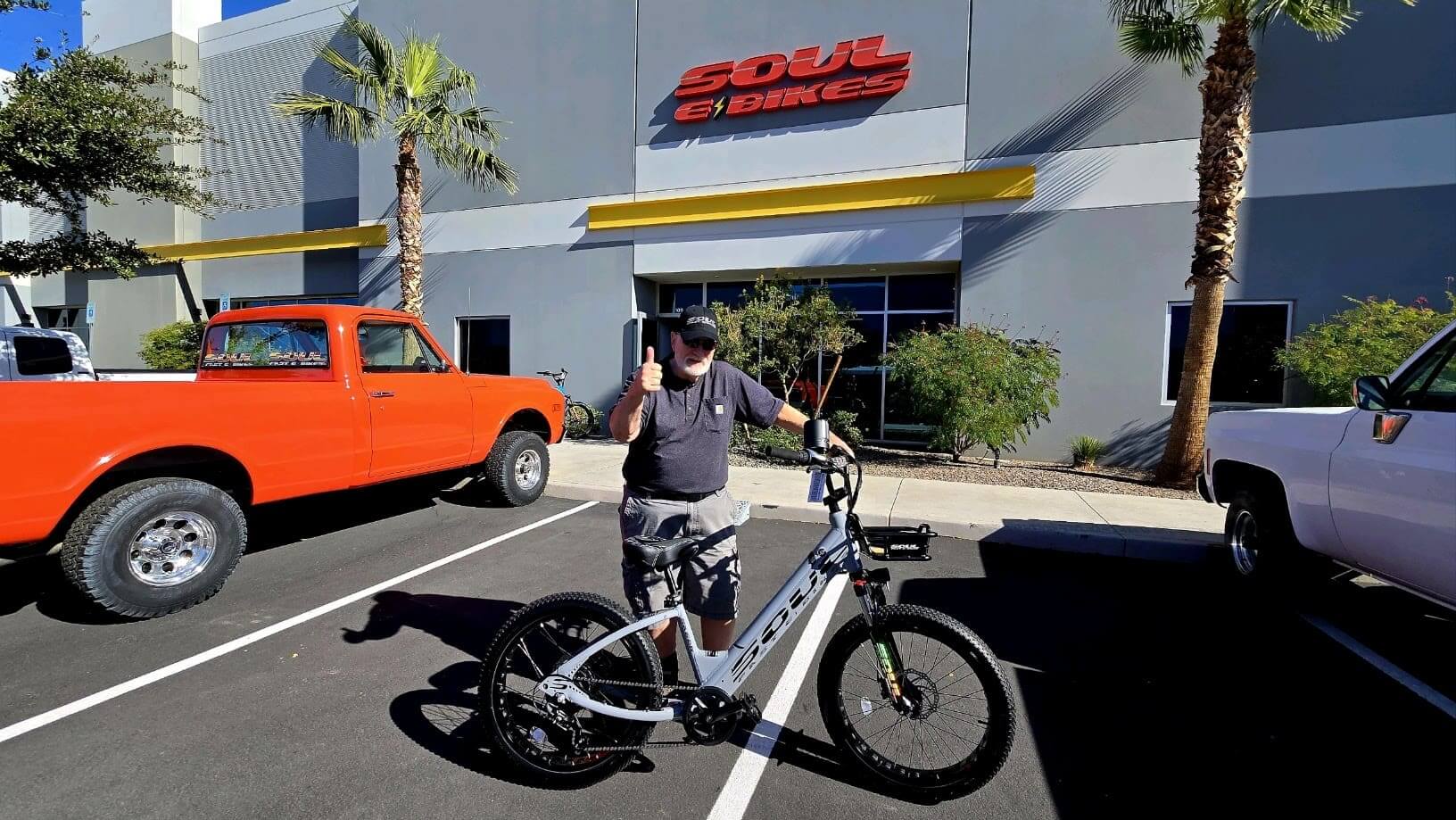 Man with bike outside Soul eBikes shop.