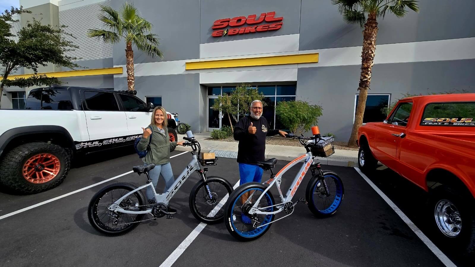 Two people with bikes outside Soul Bikes.