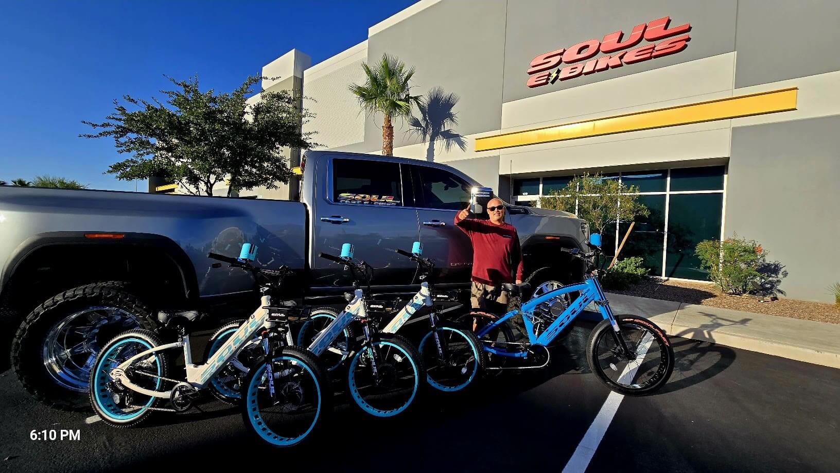 Man posing with bikes and a truck.