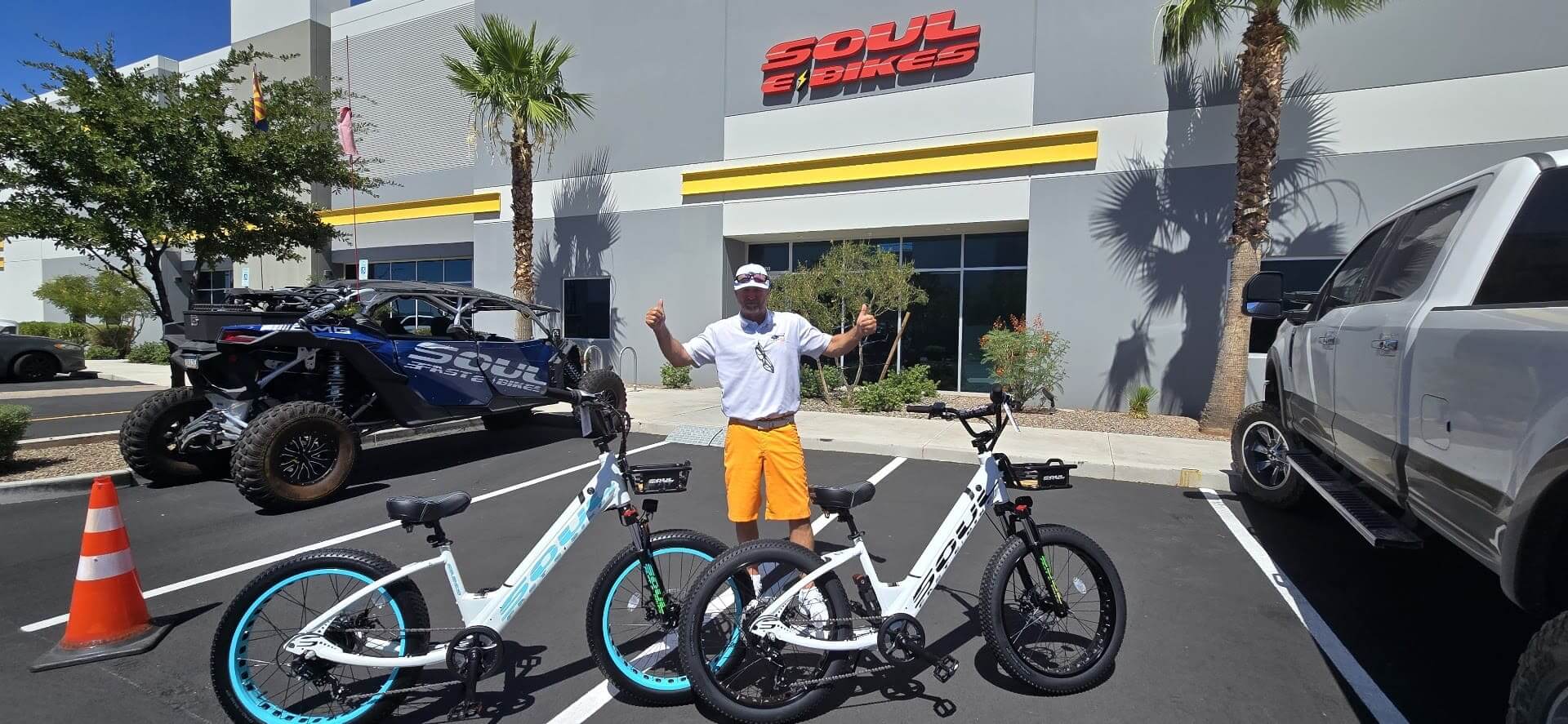 Man with electric bikes outside Soul eBikes store.