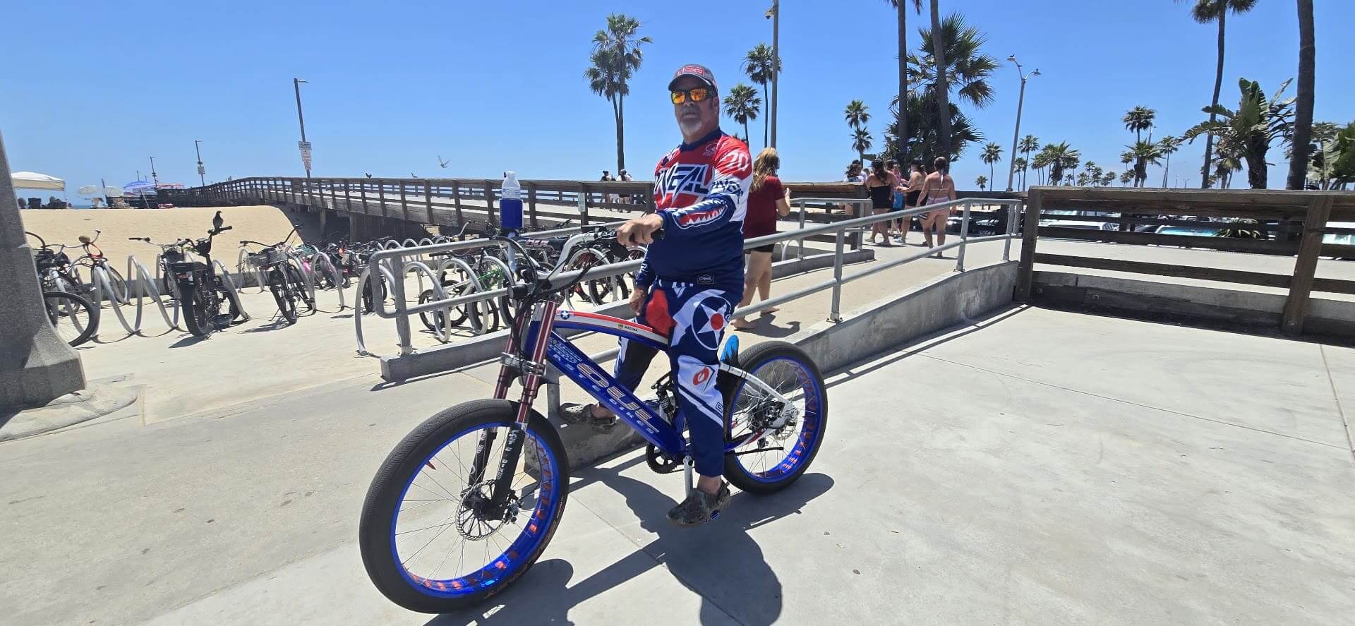 Cyclist with decorated bike at the beach.
