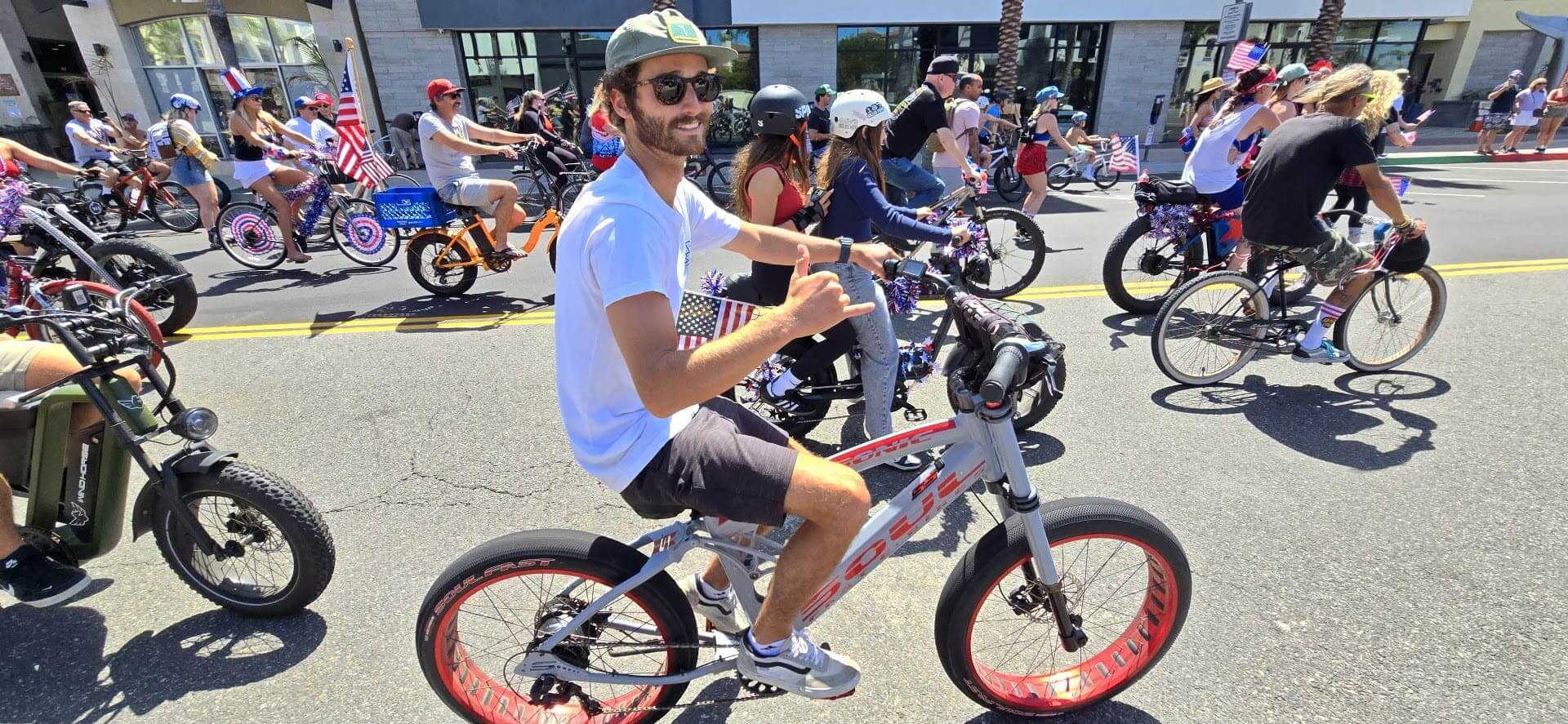 Man riding bicycle in street parade event.