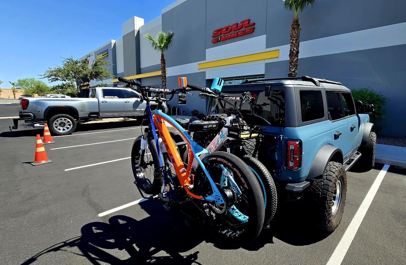 Bicycles on SUV in parking lot.