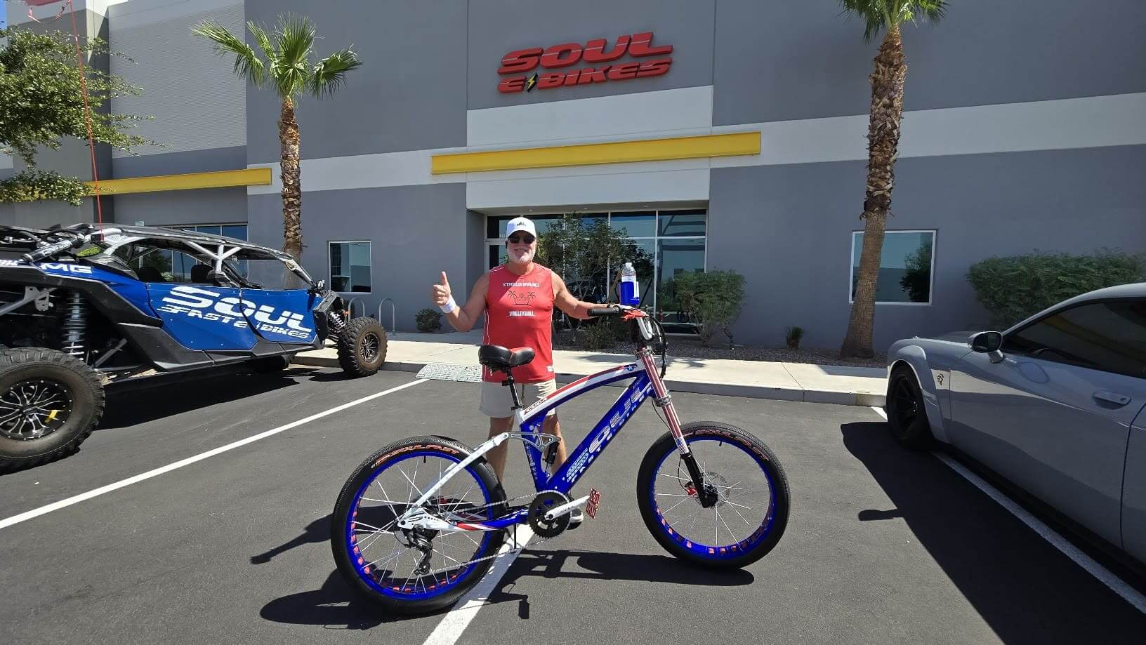 Person with bicycle outside Soul Bicycles shop.
