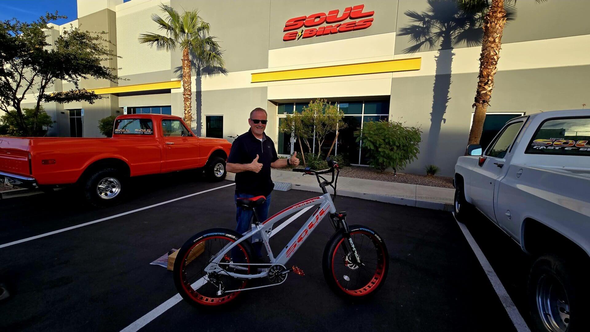Man with bike outside Soul E Bikes building.