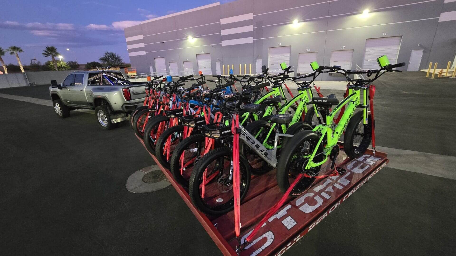 Truck hauling trailer with colorful bicycles.