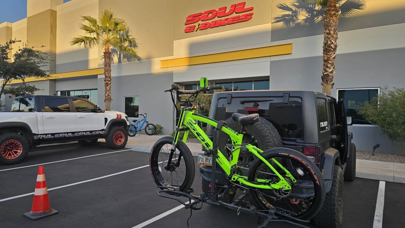 Bicycle on car rack outside bike shop.