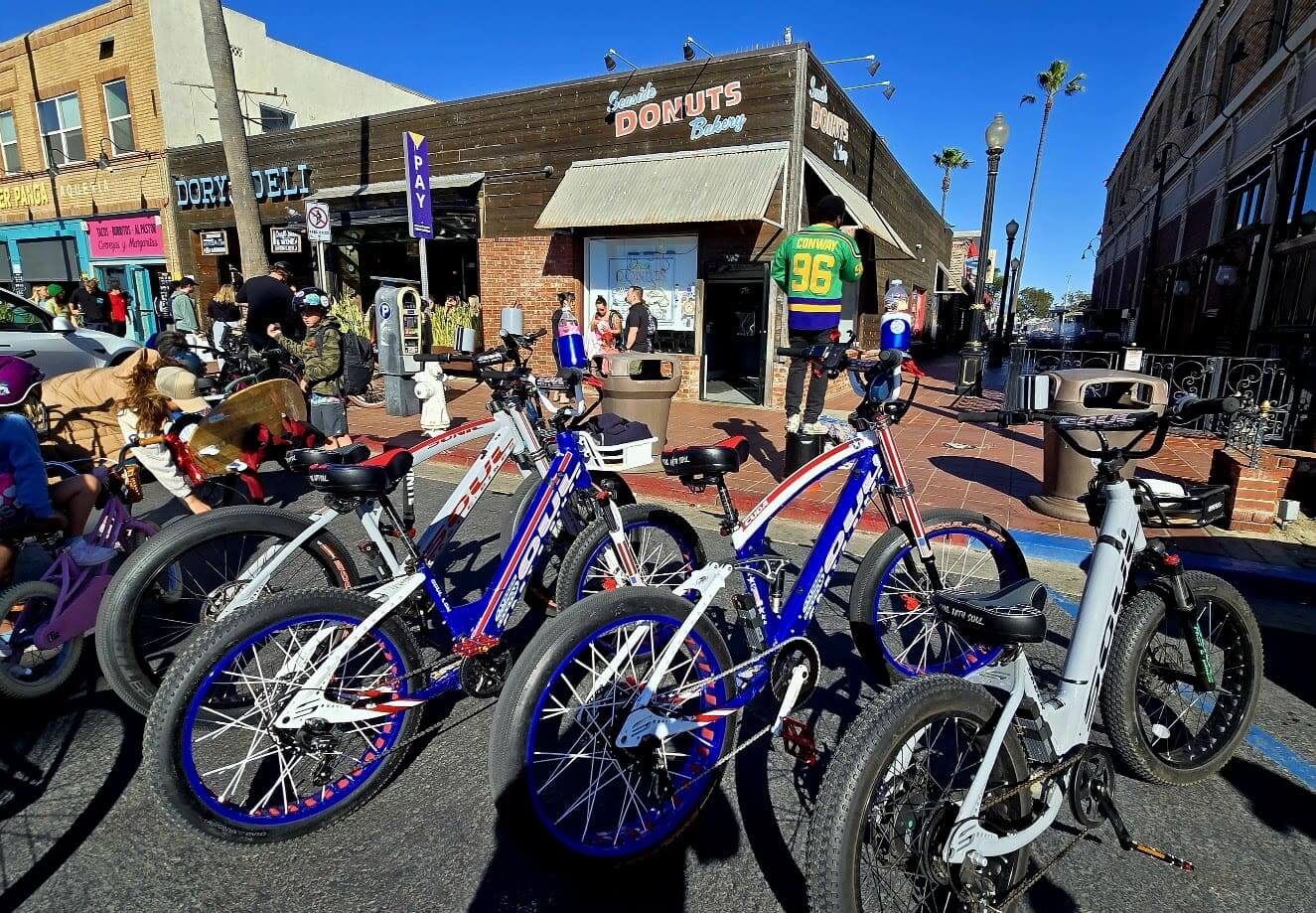 Bicycles parked outside a busy donut shop.