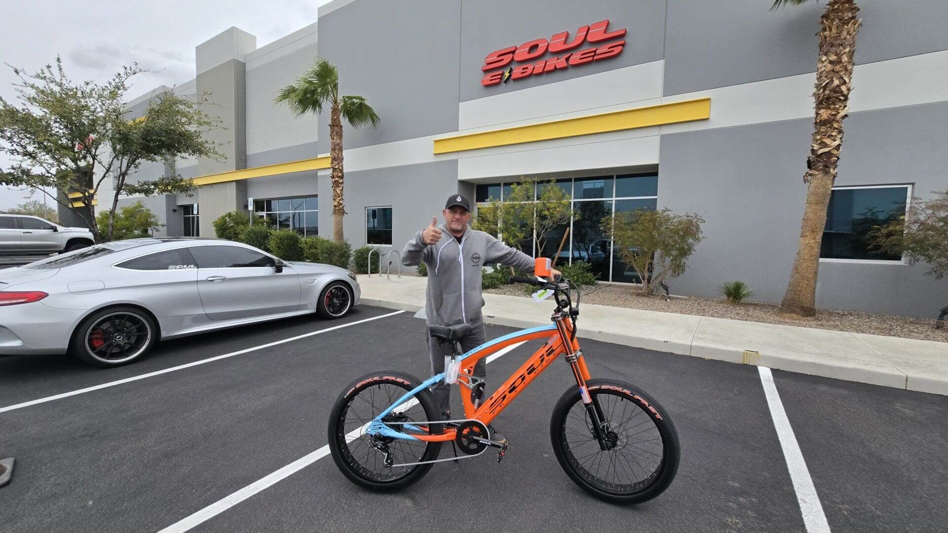 Man with bike outside Soul Bikes building.