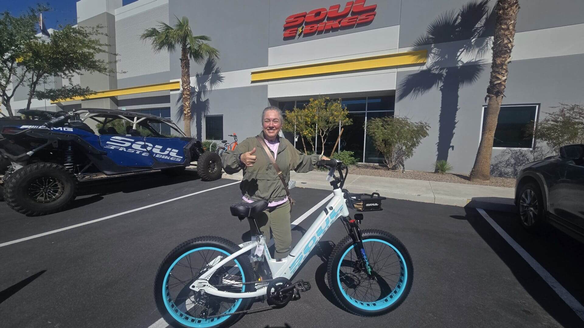 Person with bike outside Soul Bikes building.