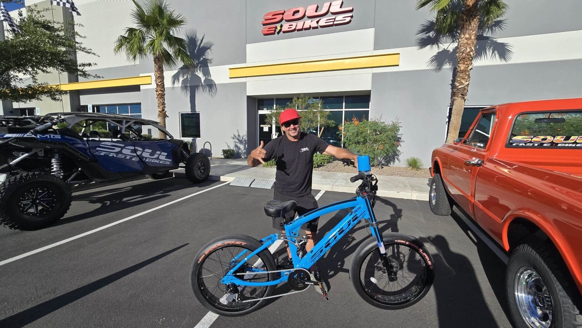 Man with bicycle outside Soul Bikes shop.