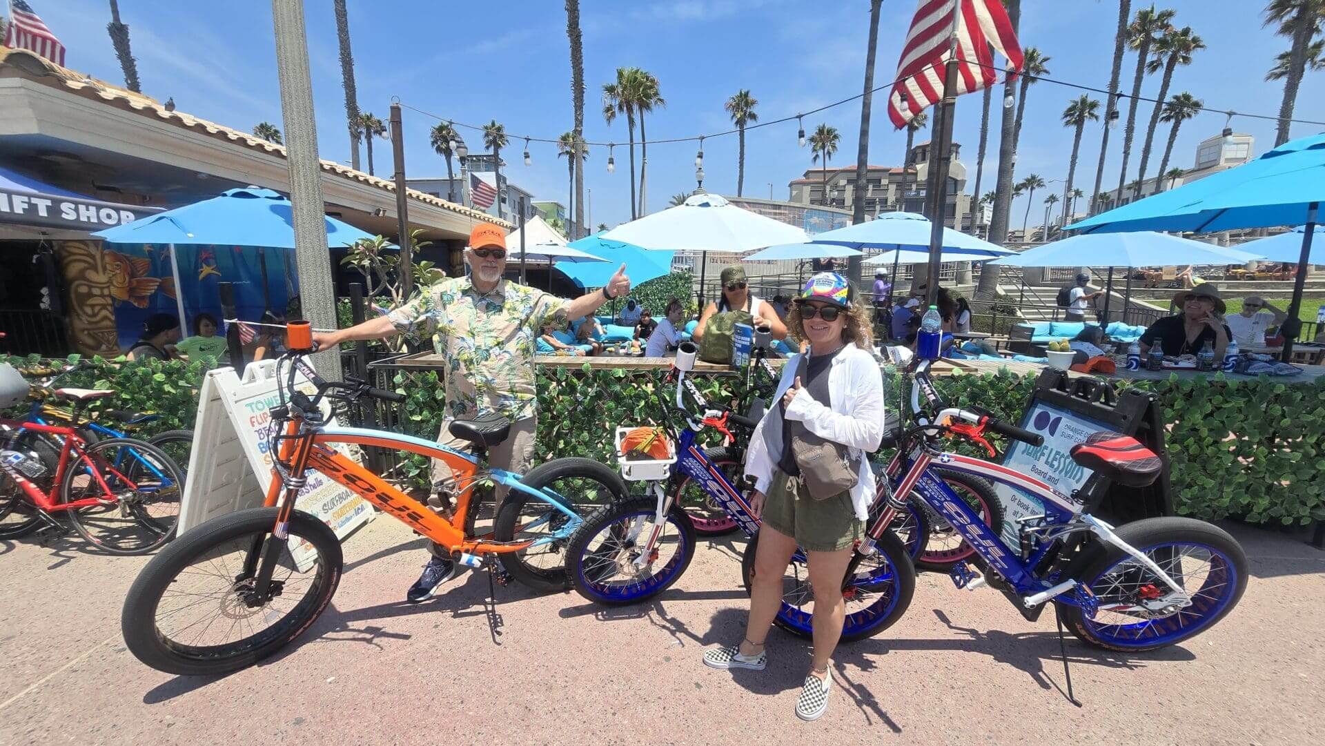People with bikes near beachside cafe.