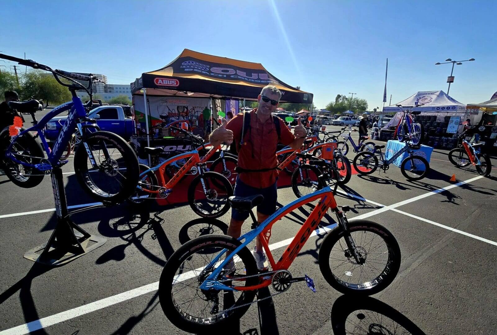 Man at outdoor bicycle exhibition event.