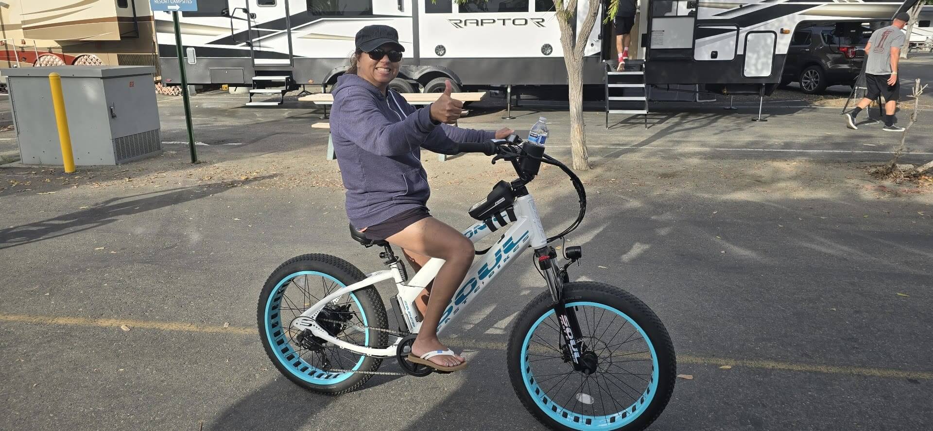 Person riding a bicycle in parking area.