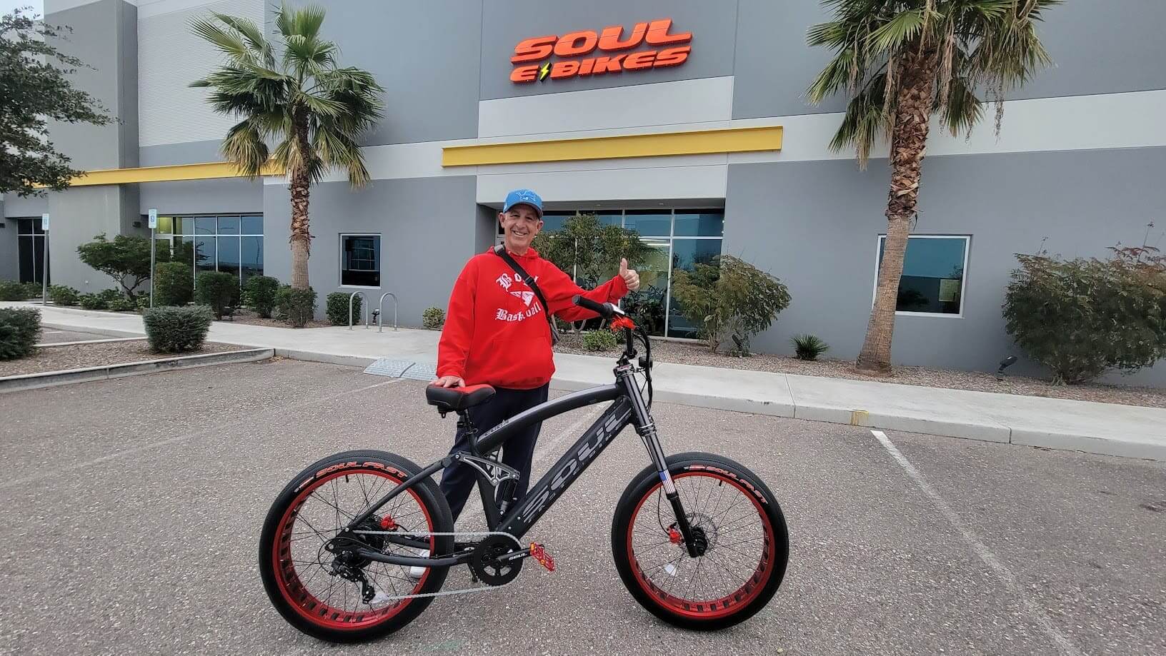 Person with bike in front of store.