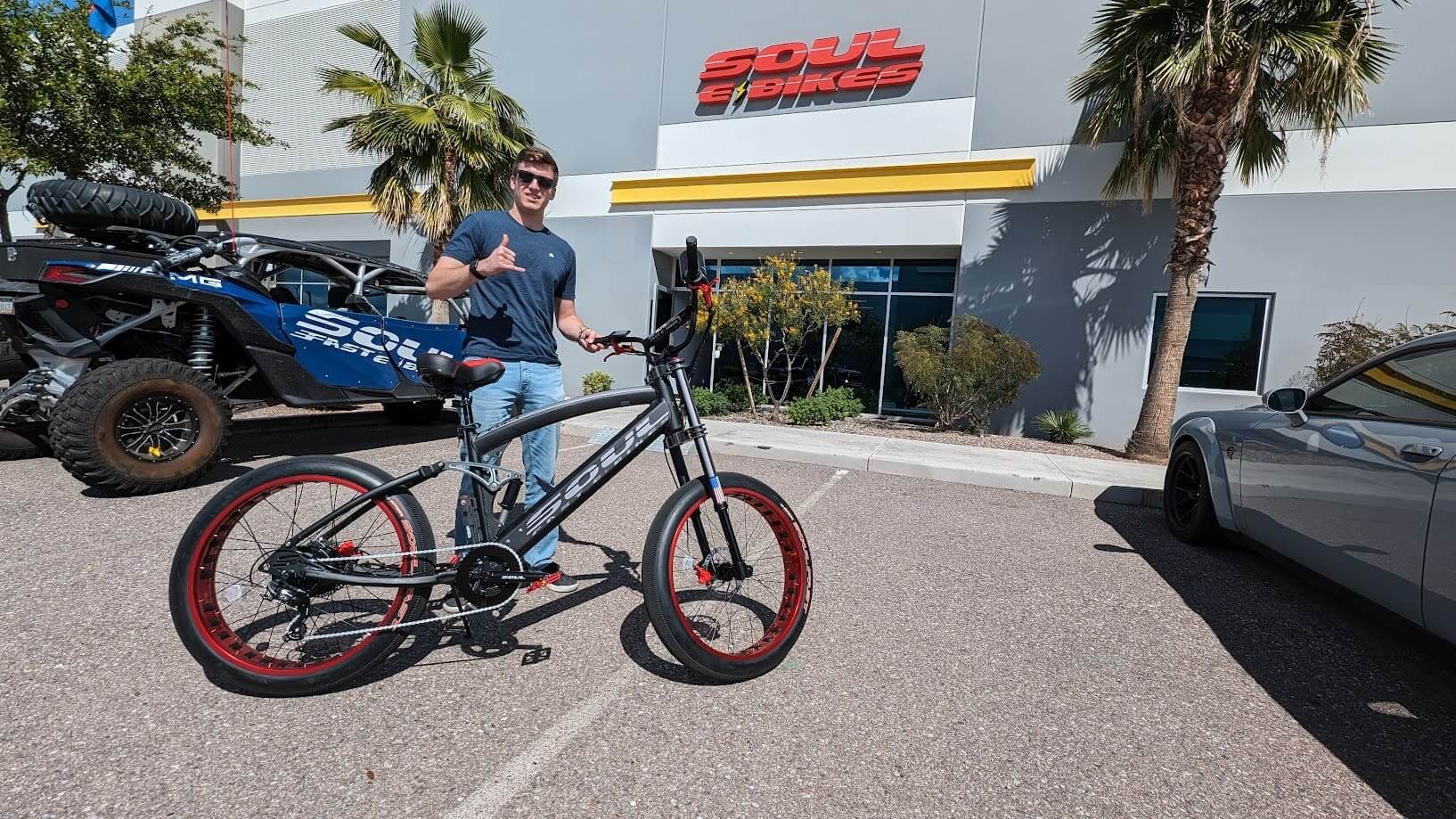 Man posing with bicycle outside Soul E Bikes.