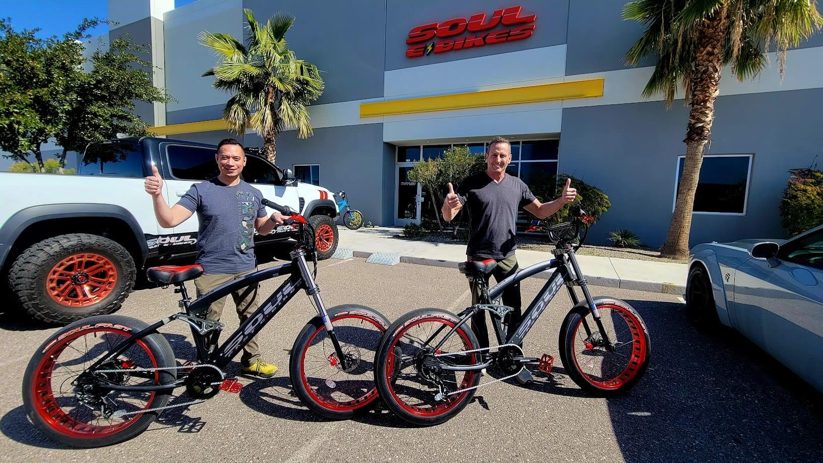 Two men with bicycles outside Soul Bikes.