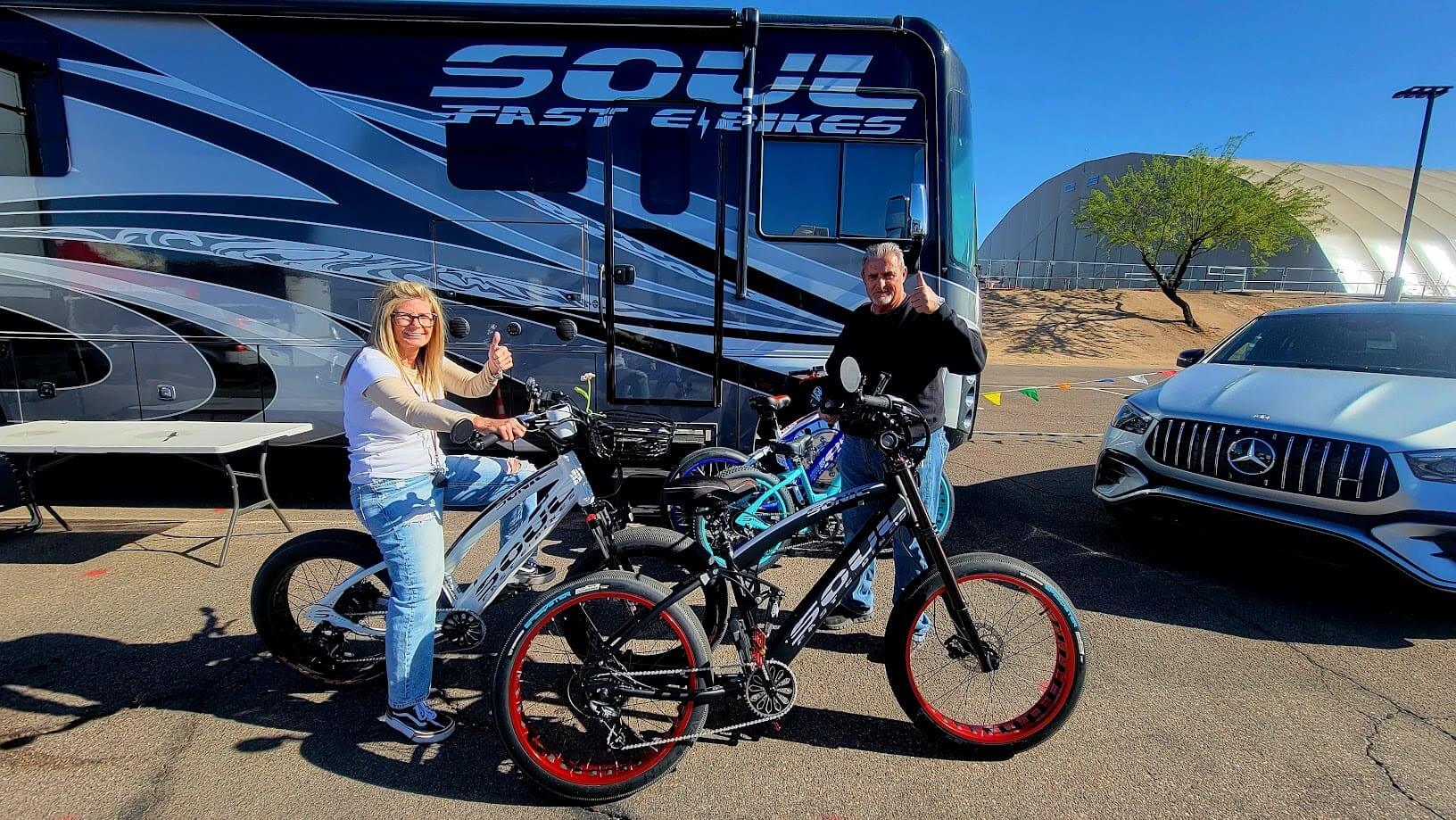 People with bikes in front of RV.