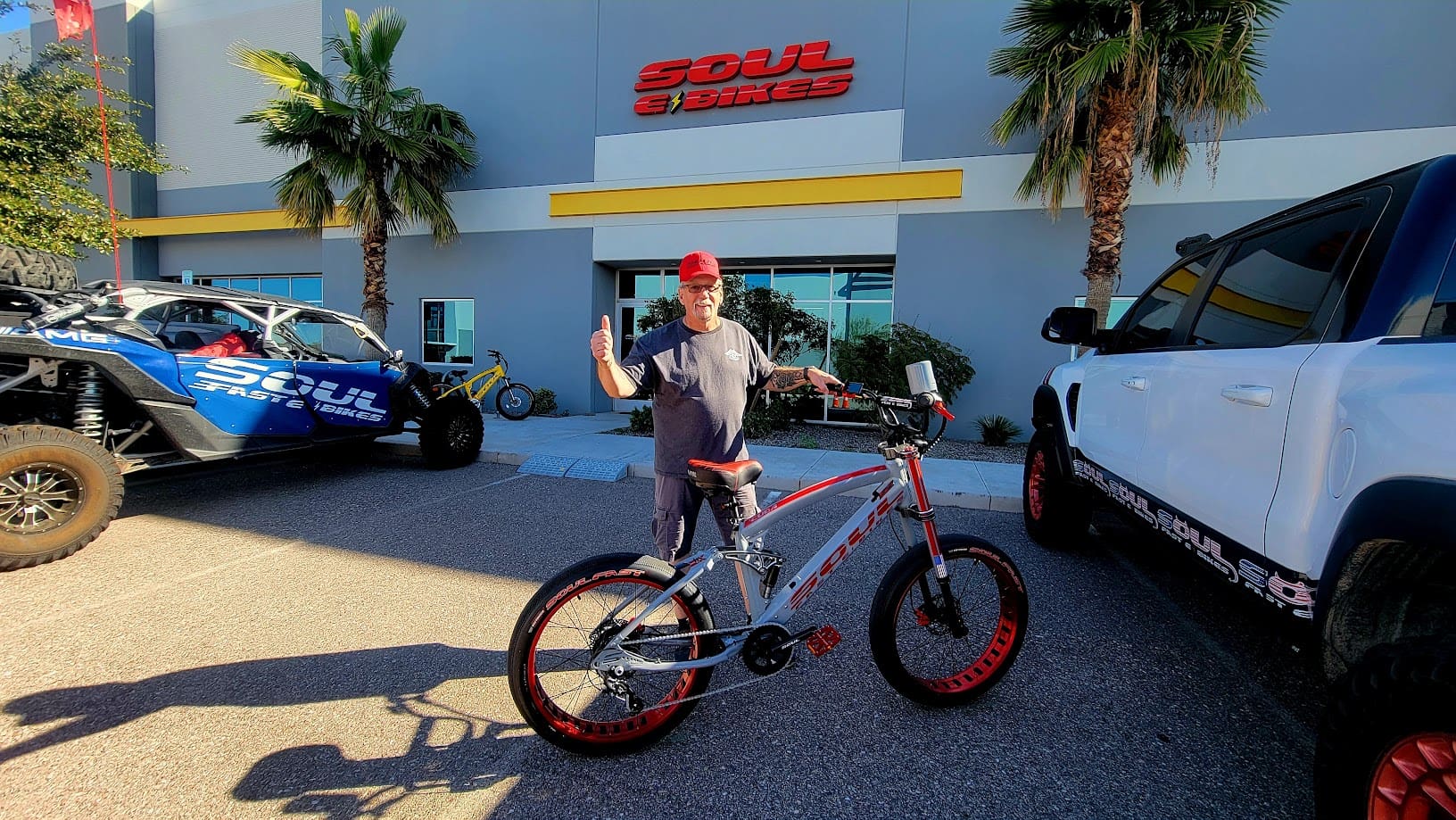 Man posing with bicycle outside Soul Bikes shop.