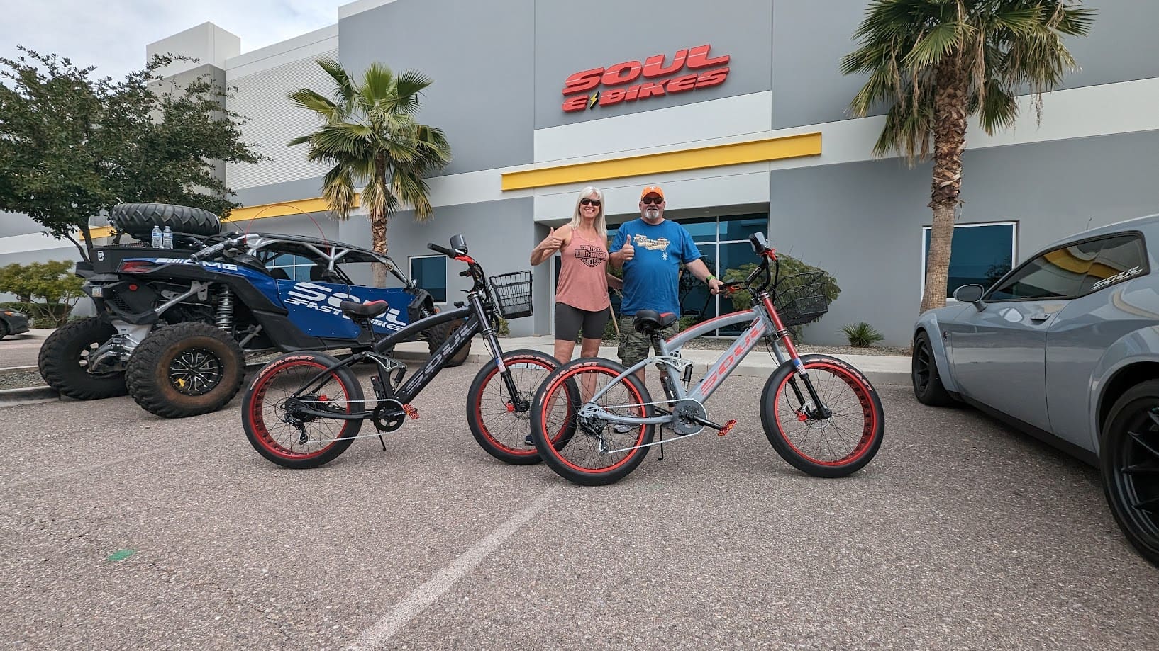 Two people with bicycles outside Soul Bikes.