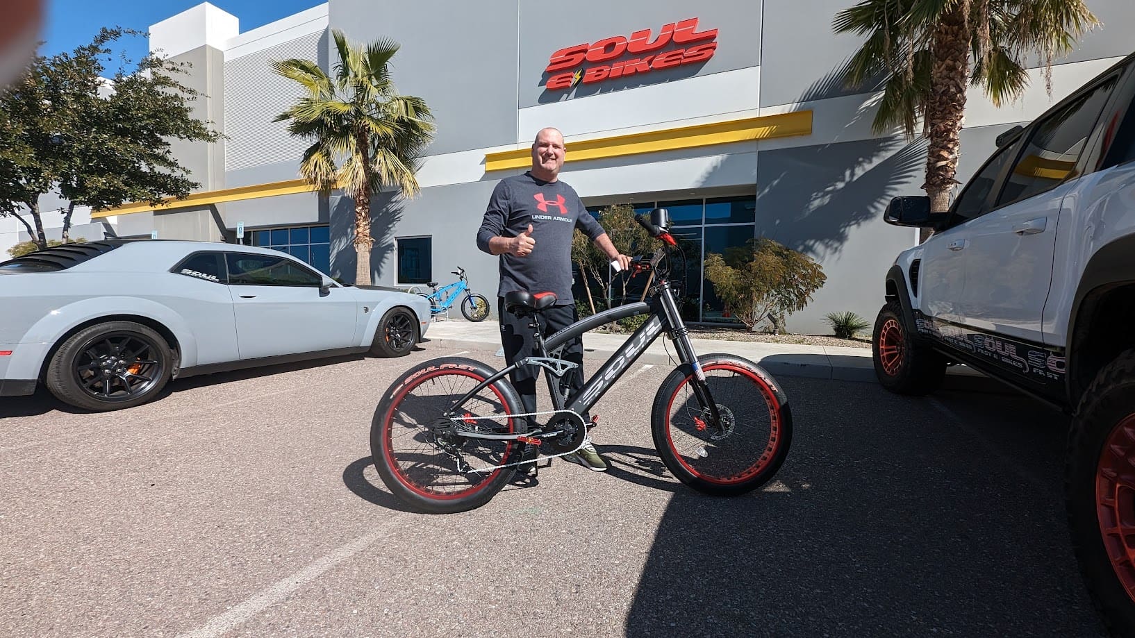 Man with bicycle outside Soul Bikes store.