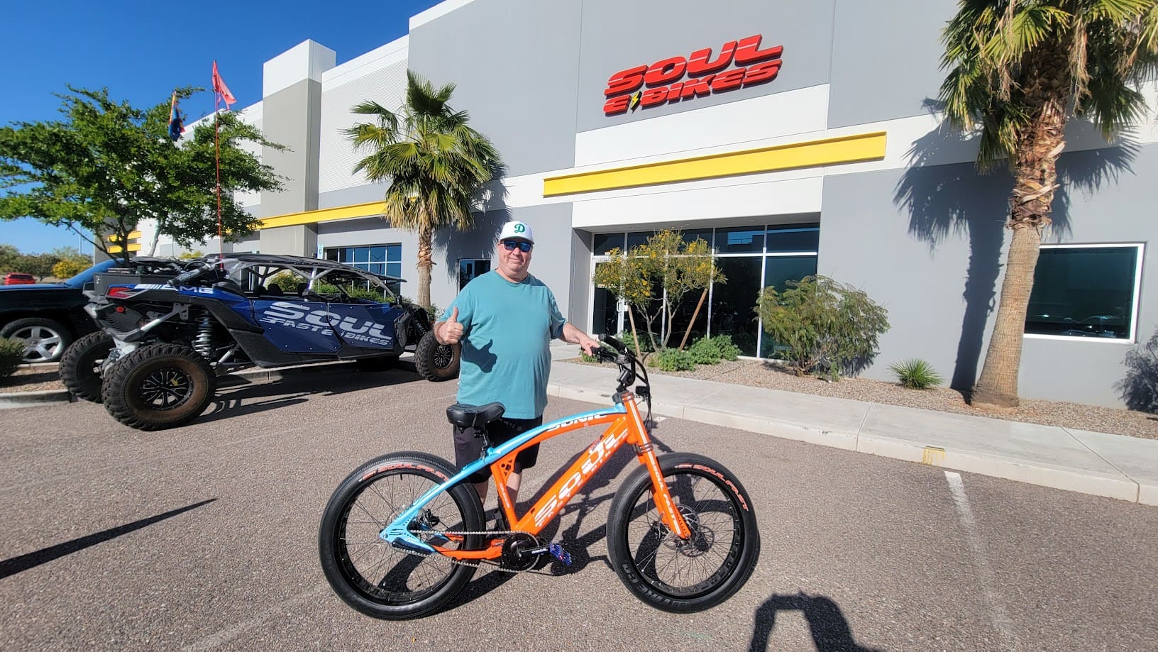 Person with orange bike outside Soul Cycles.