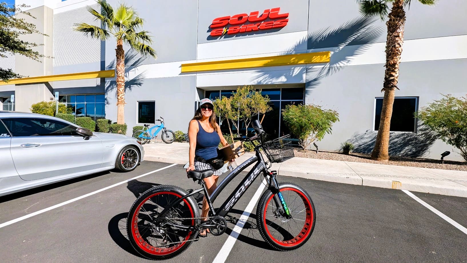 Woman standing with bike outside Soul Bikes.