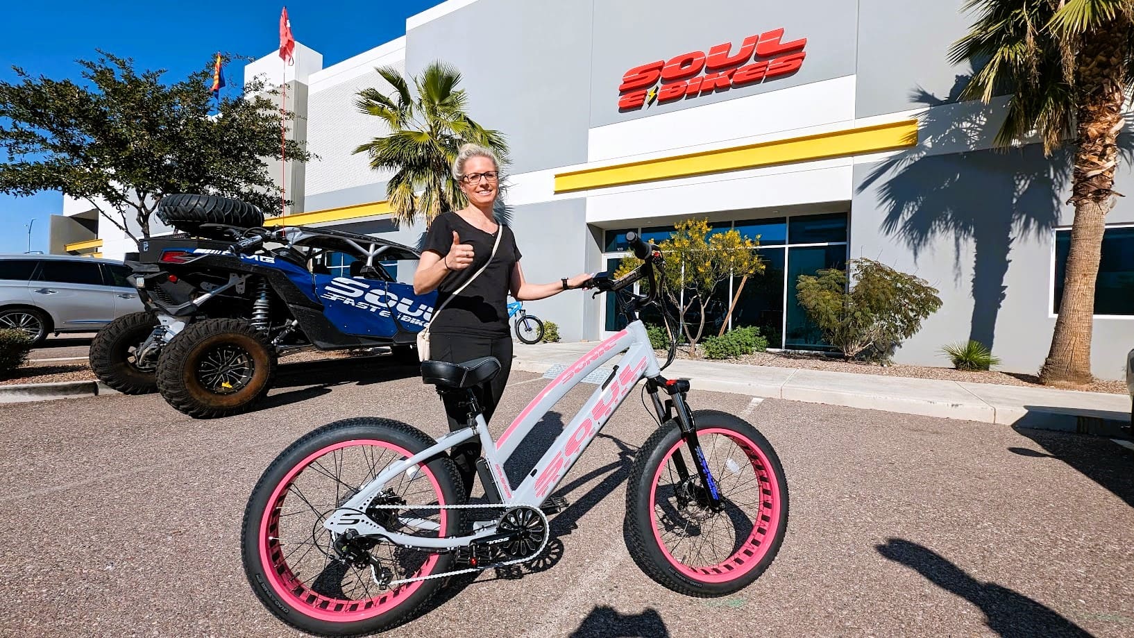 Person with bike outside Soul eBikes store.