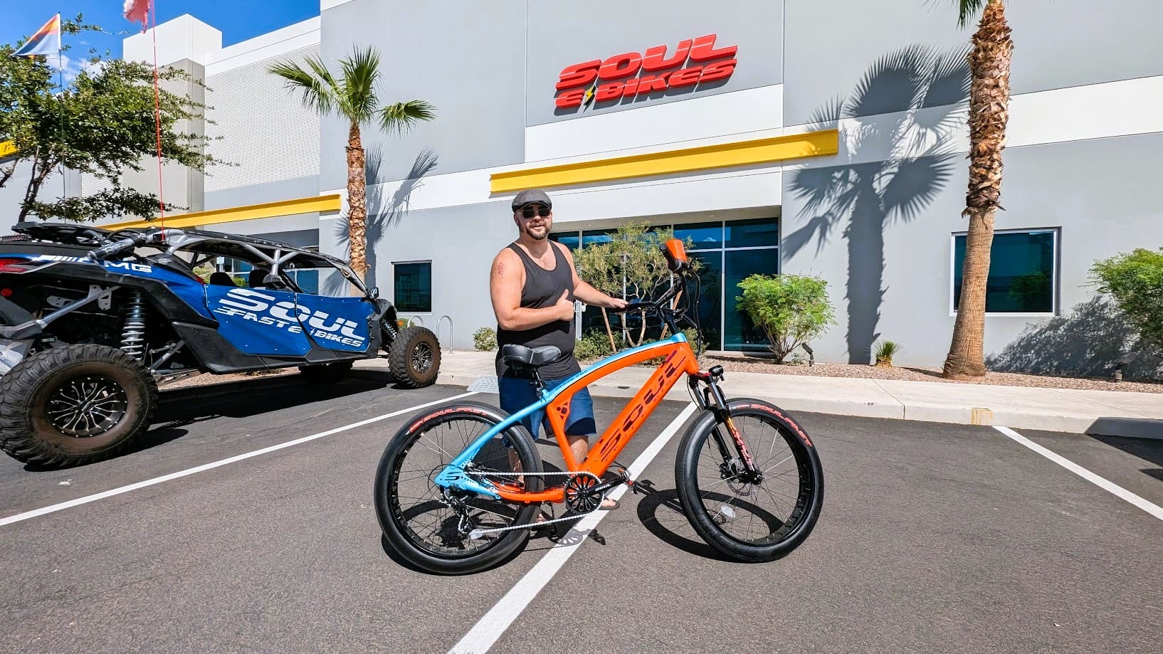 Man with electric bike outside Soul Bikes store.