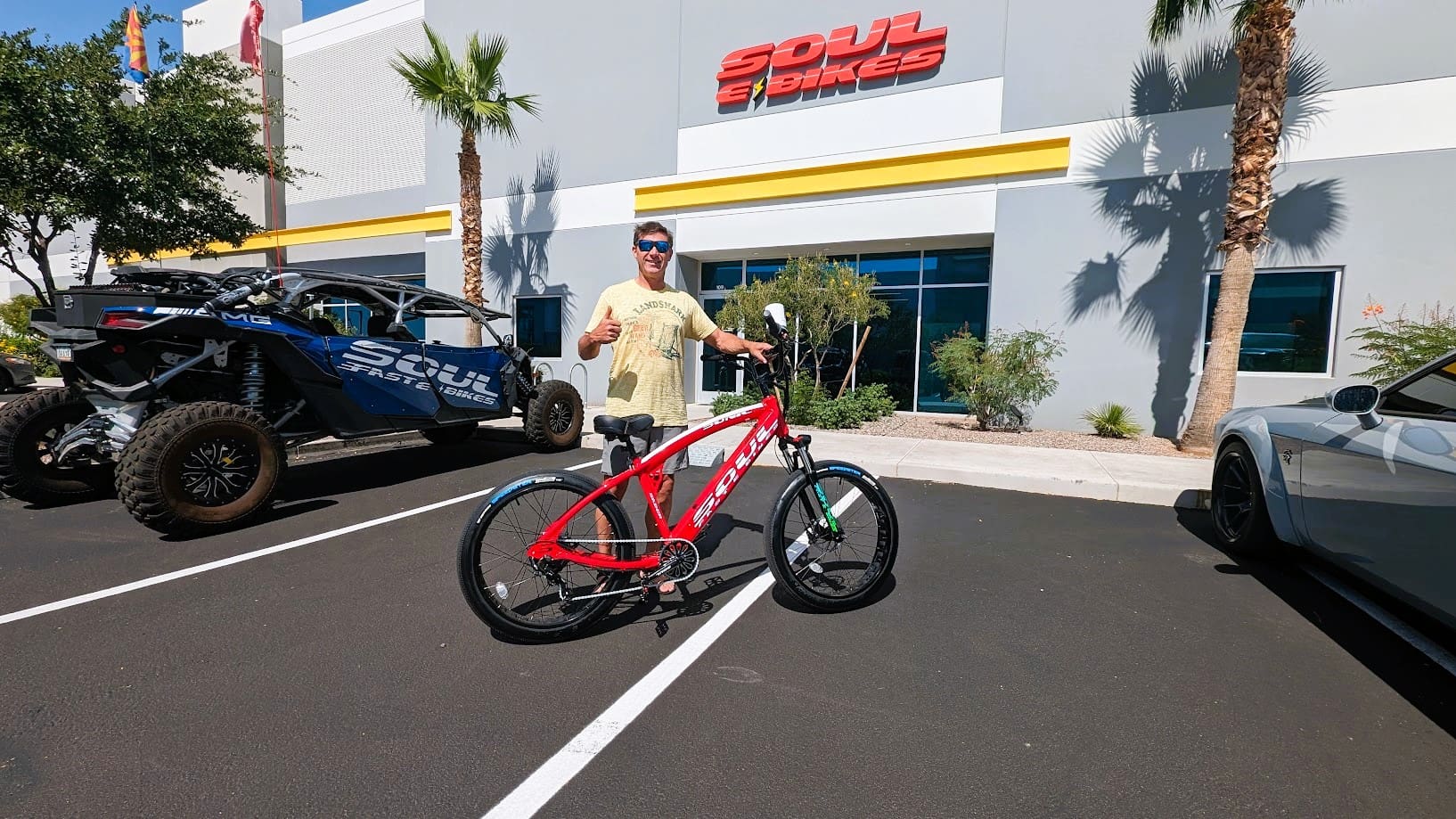 Man with red bike outside Soul Bikes store.