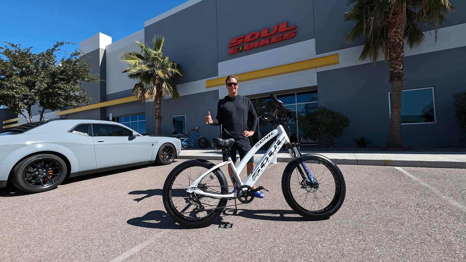 Person with bike outside Soul Bikes store.