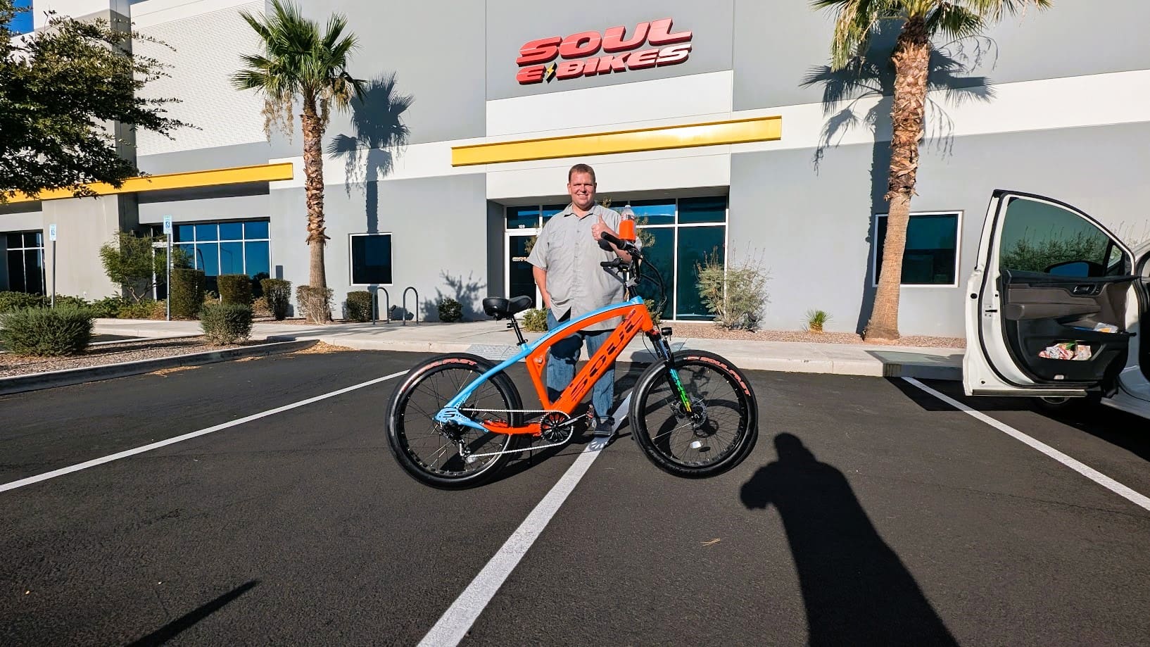 Man with bike outside Soul Bikes building.