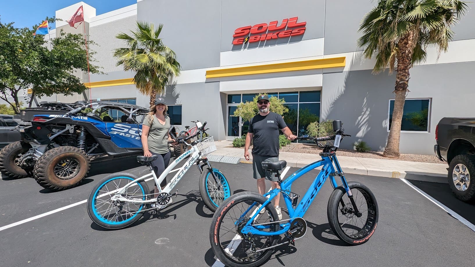 People with bicycles outside Soul eBikes store.