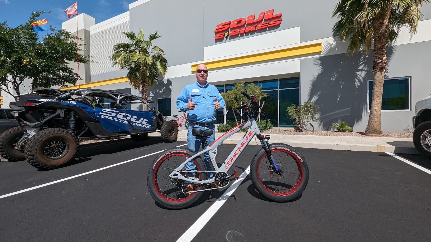 Man with bike outside Soul of Synergy store.