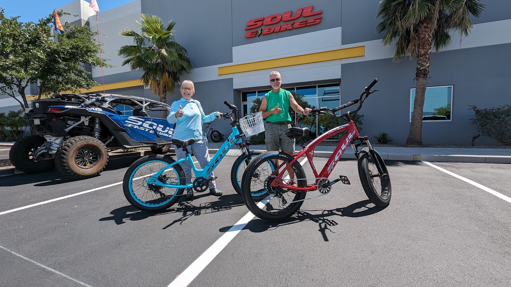 Two people with bikes outside a store.