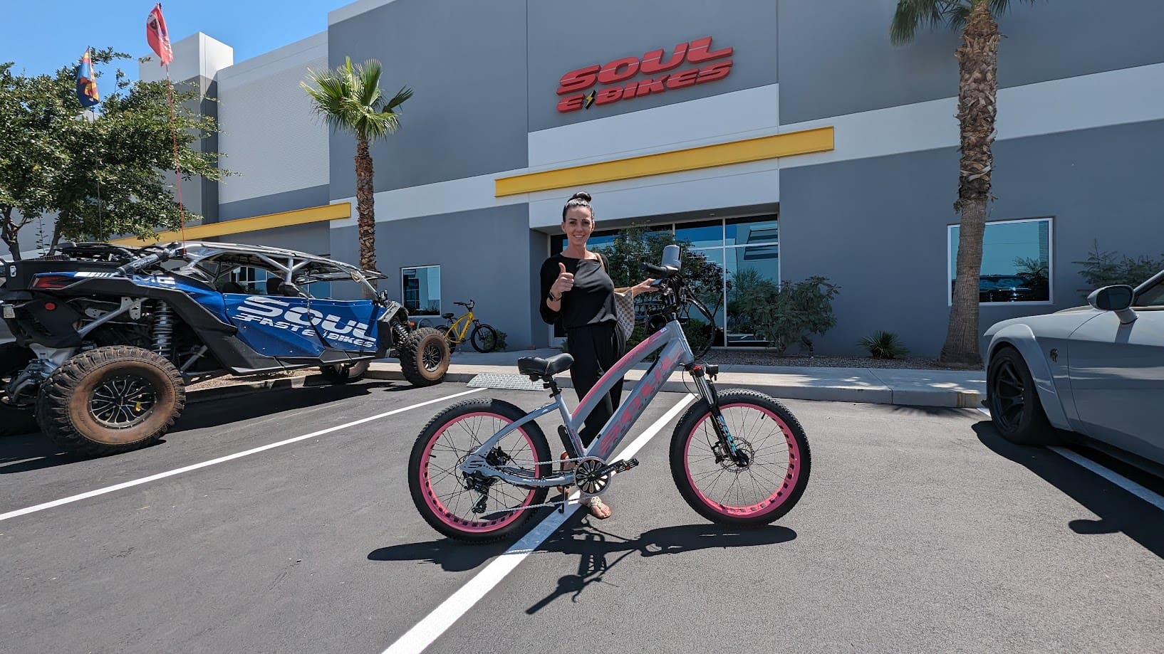 Person with bike outside Soul e Bikes store.