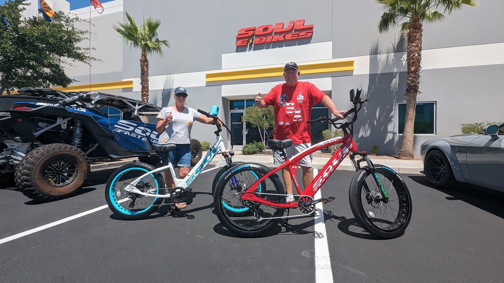 Two people with bicycles outside Soul Bikes.