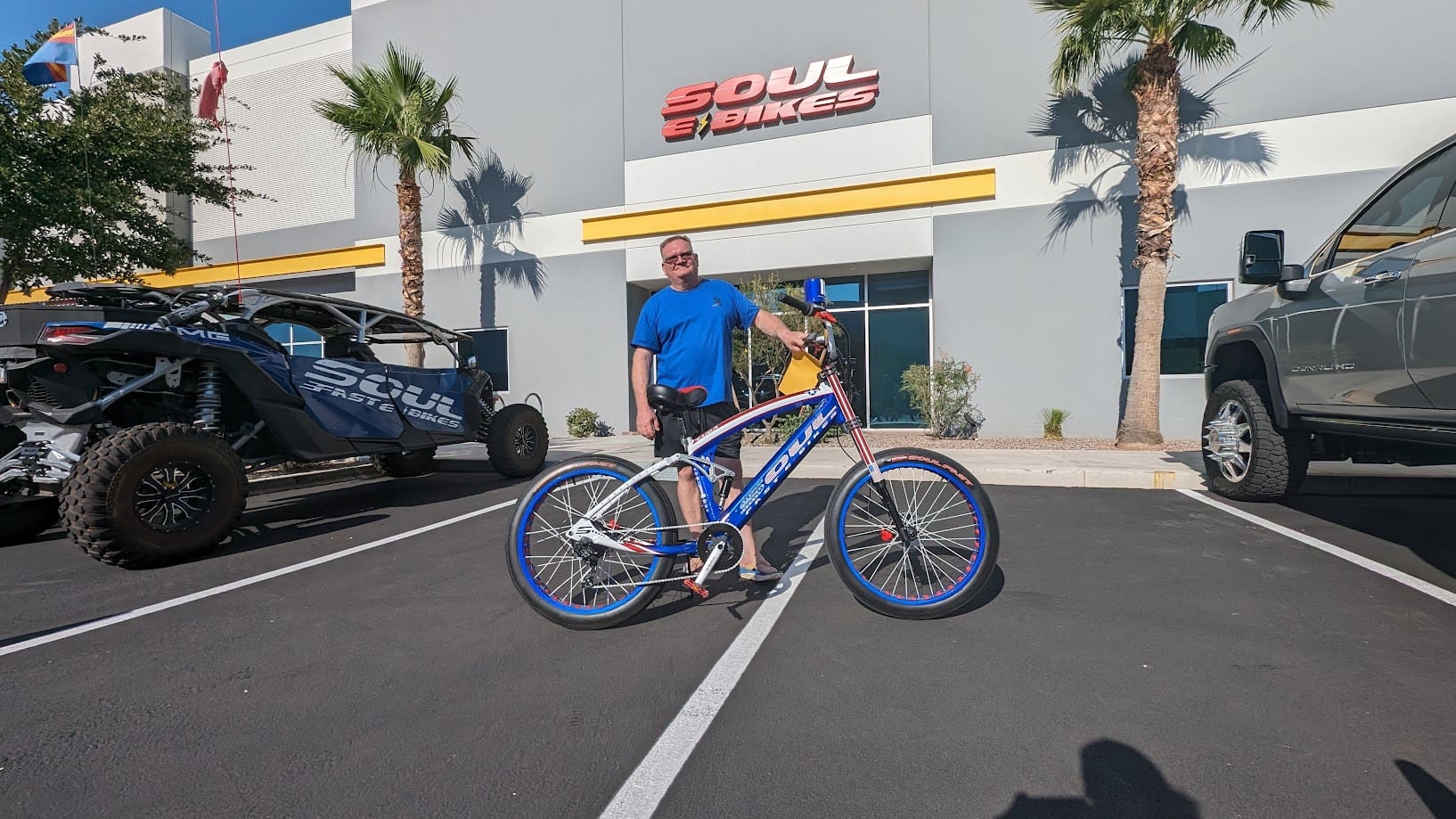 Man with bicycle outside Soul Bikes store.