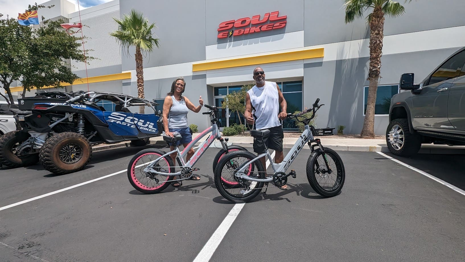 Two people with bikes outside Soul Bikes.