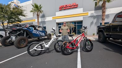 Person with bicycles outside a store.