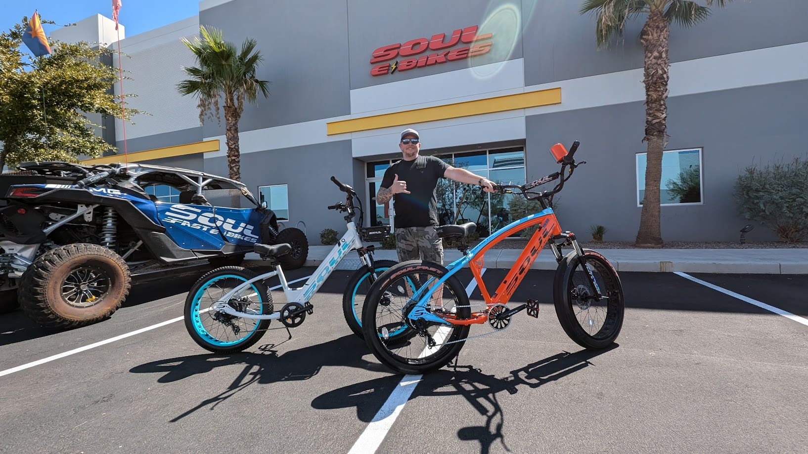 Man with bicycles outside Soul eBikes store.