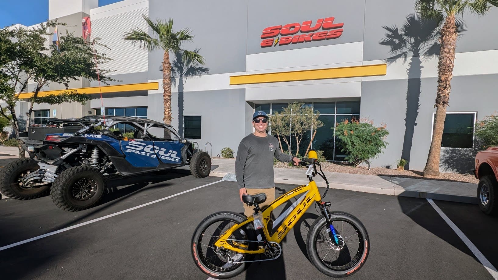 Man with yellow bike outside Soul showroom.