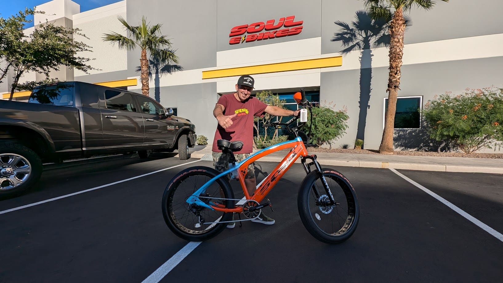 Man with bike in parking lot.