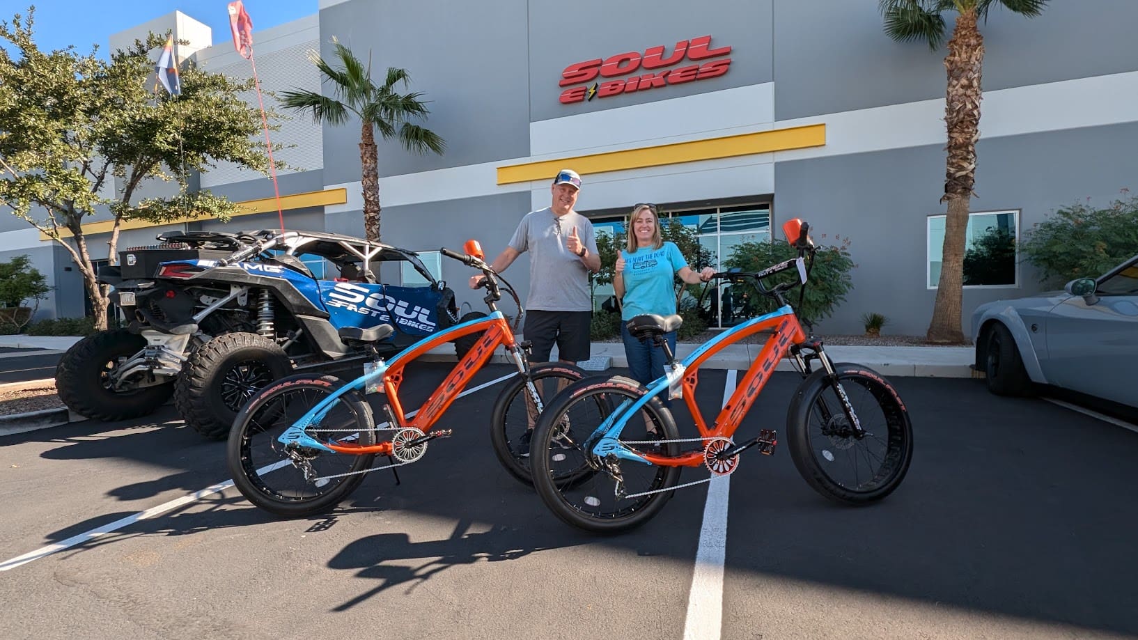 Two people with bikes outside Soul Bikes.