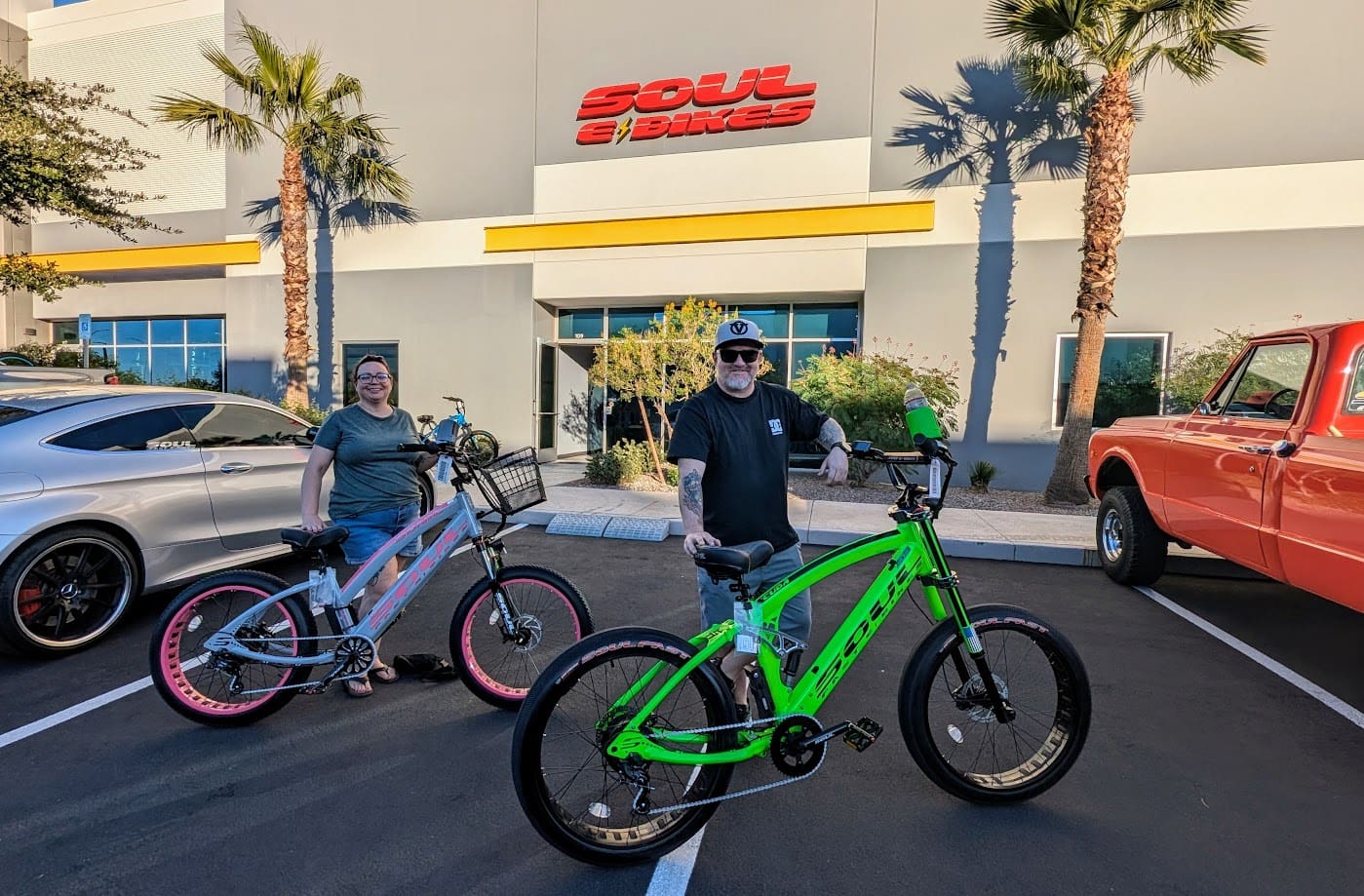 People with electric bikes outside a store.