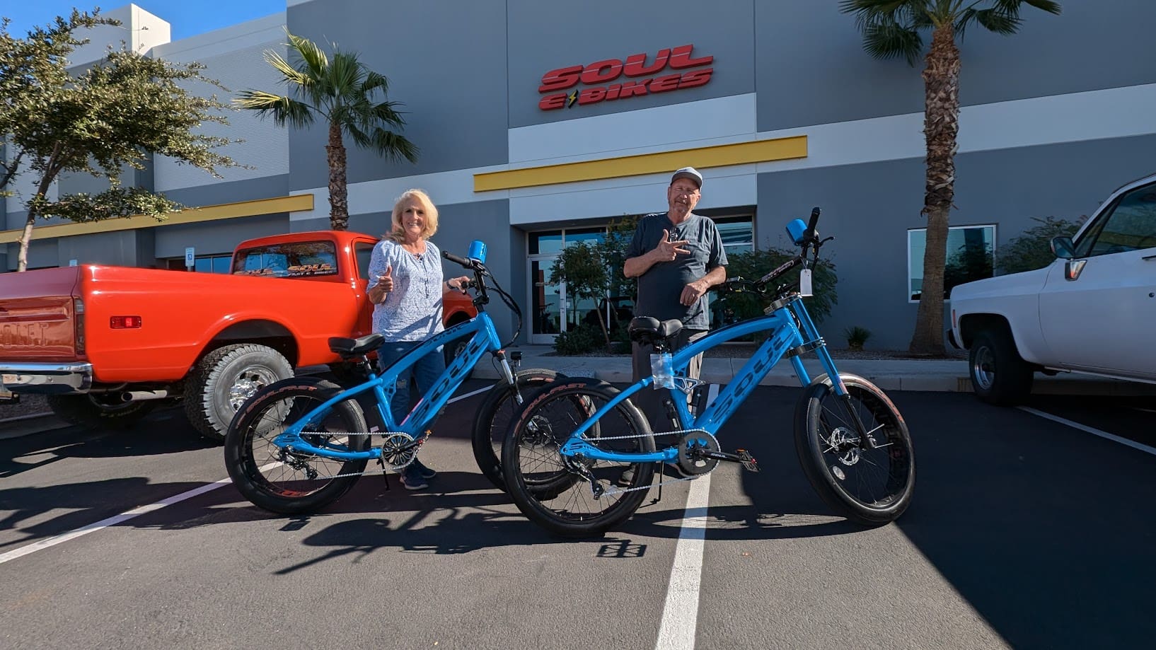People with blue bikes outside Soul E Bikes.
