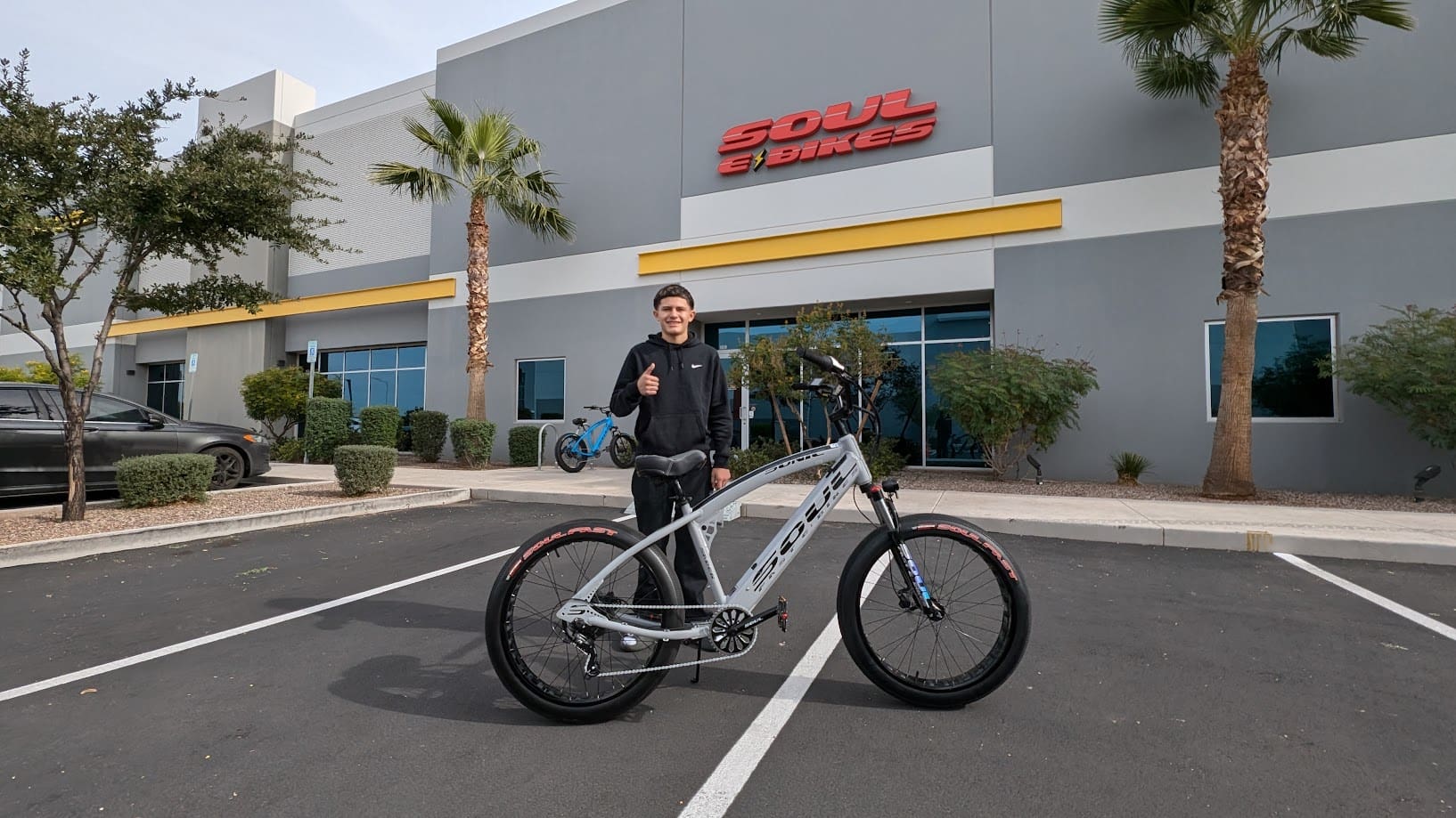 Person posing with bike outside Soul Bikes.