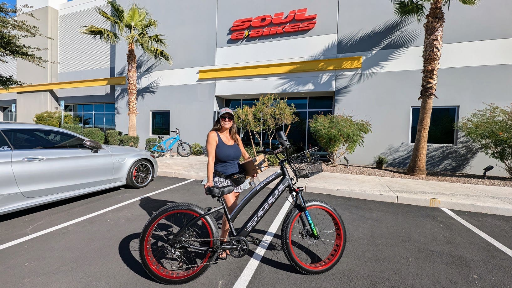 Woman posing with bicycle outside Soul Bikes.